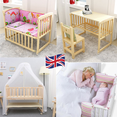 baby cot next to bed