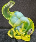 Vintage Fenton Vaseline Uranium Opalescent Glass Trunk Up Elephant. With label.