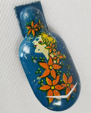 Vintage Tin Lithograph Clicker Noisemaker with A Woman Head and Flowers Design