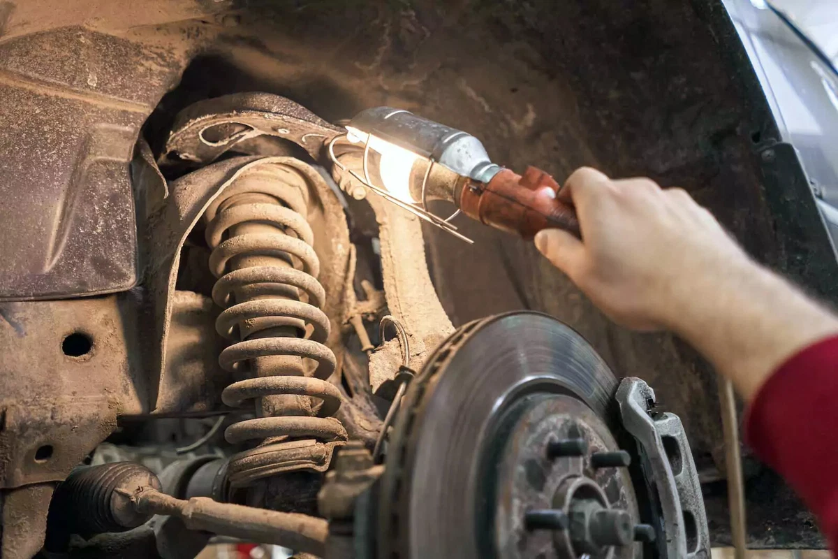 A vehicle's shock absorber shown installed with the vehicle's wheel removed.