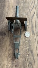Vintage metal miniature or toy cannon, possibly cast iron or die-cast metal.