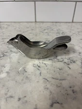 Vintage stainless steel bird-shaped citrus squeezer.