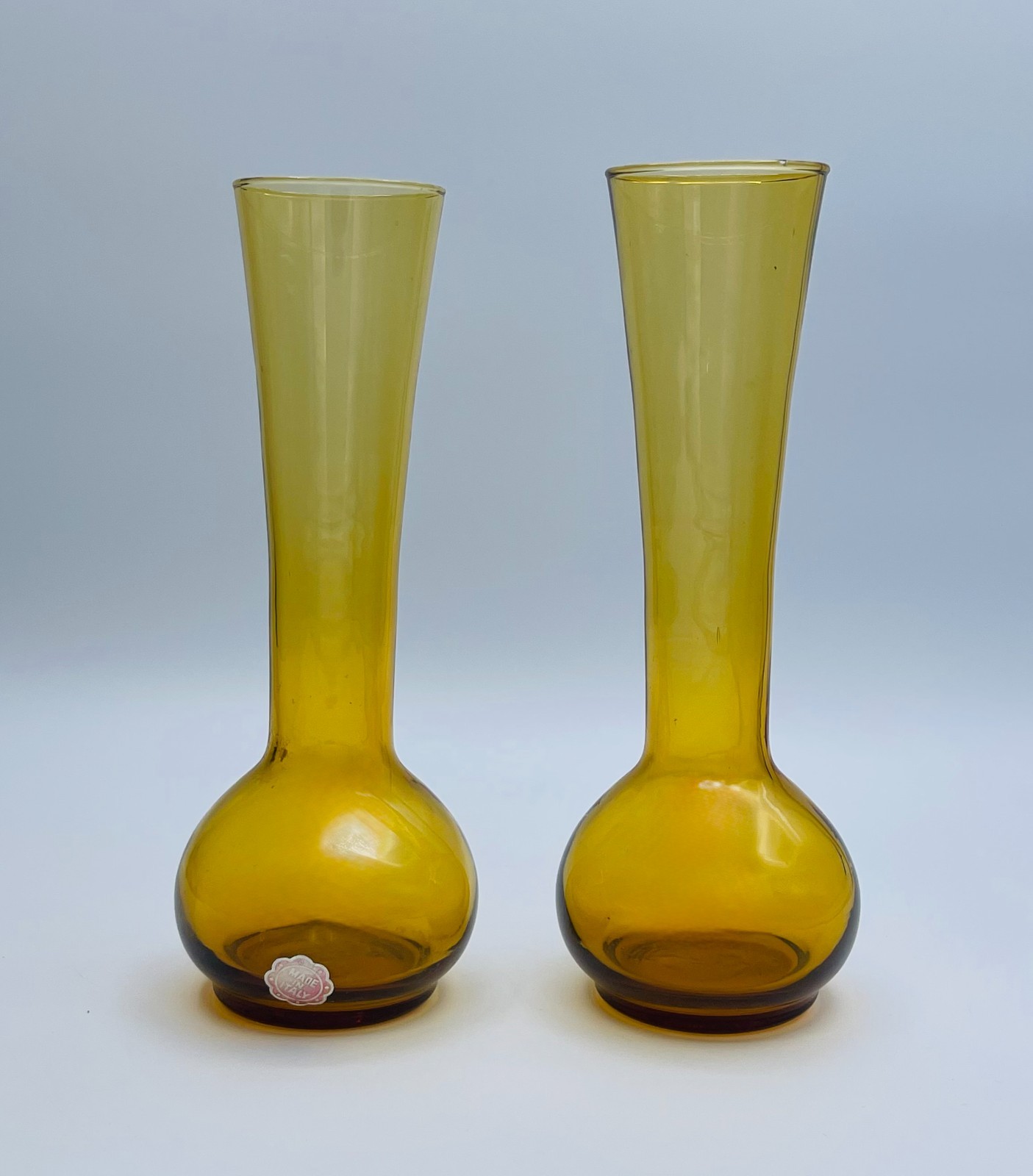 Pair of tall amber glass bud vases with bulbous bases