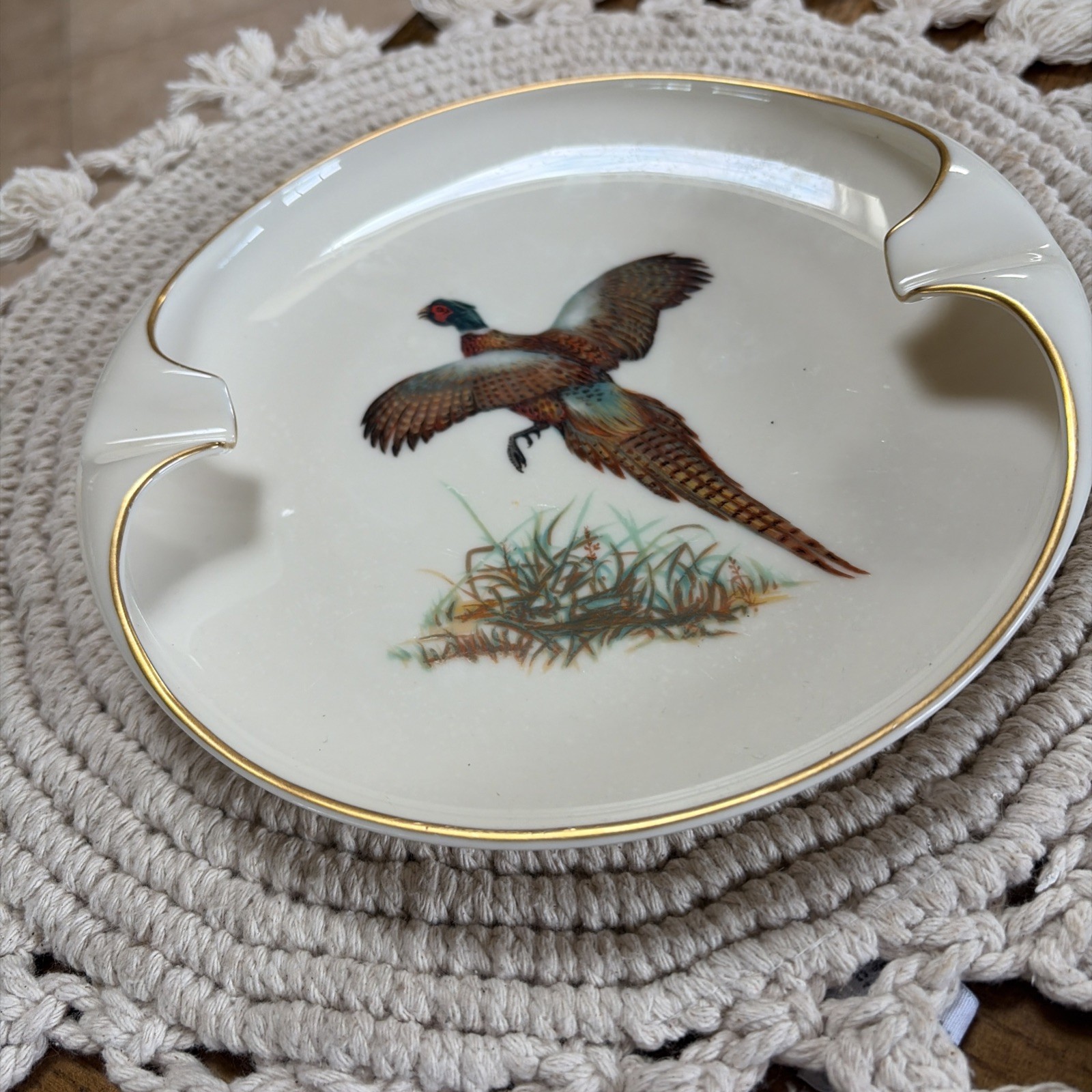 Lenox porcelain ashtray with gold trim, featuring colorful pheasant bird design and gold cigarette rests.