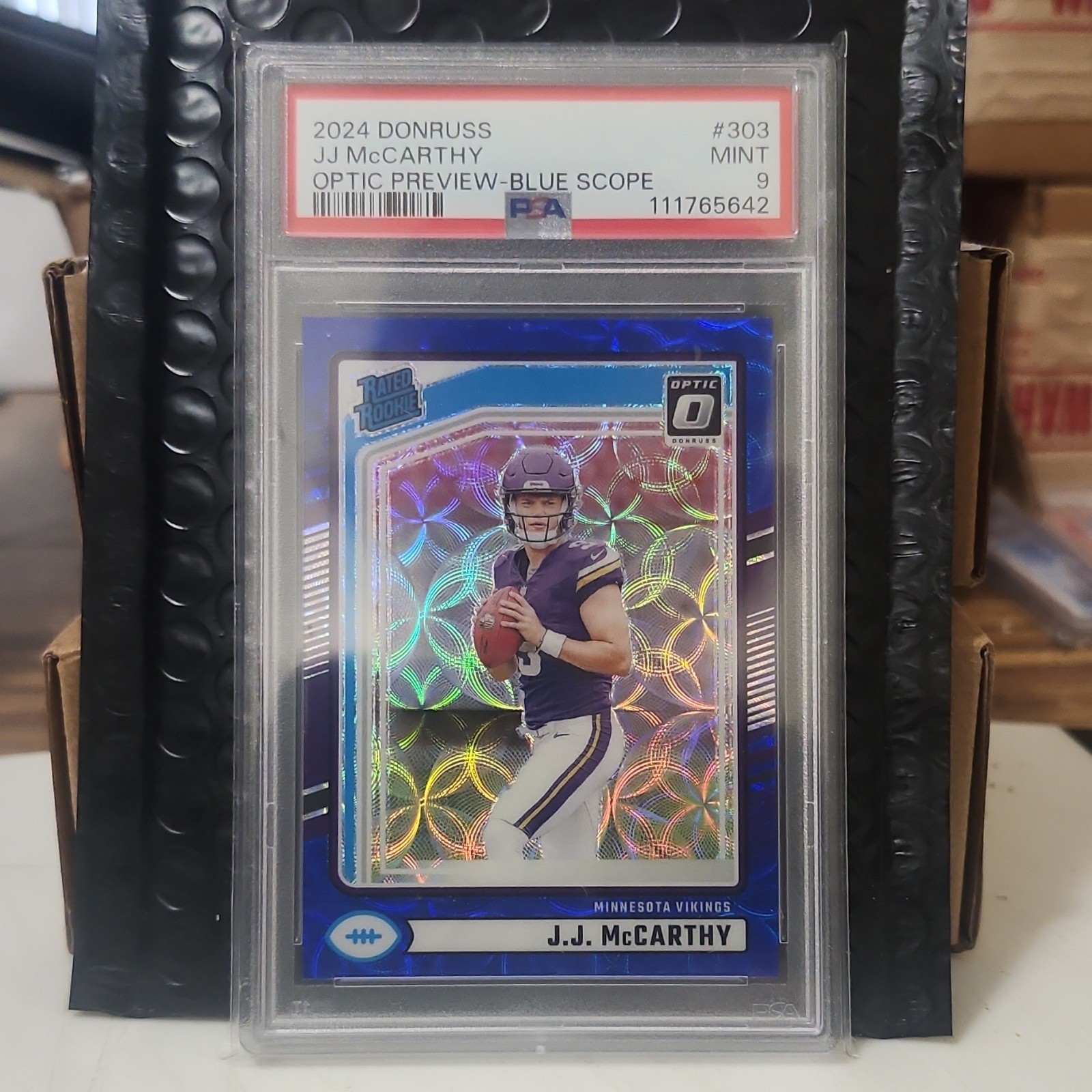 Panini 2024 Donruss Rated Rookie J.J. McCarthy #303 Optic Preview Blue Scope PS…