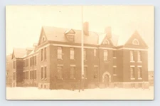 Old Gabled Building Multi-Paned Windows in the Snow with Huge Flagpole RPPC