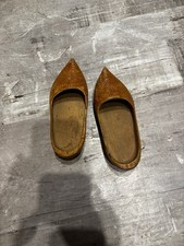 These are a pair of hand-carved wooden clogs, also known as "klompen" in Dutch