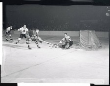 Hockey Players in Action 1955 Photo - Sid Smith, , of Toronto, shoots at Black H