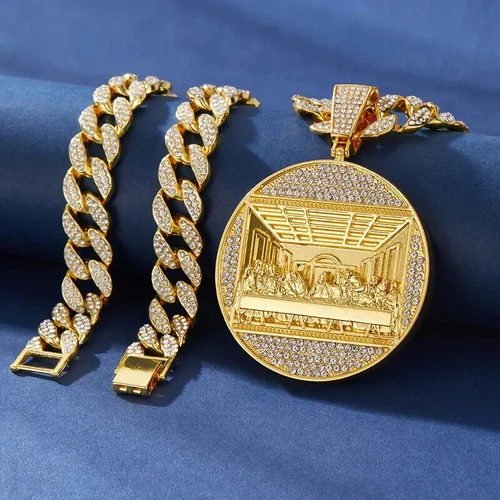 Gold-plated Cuban chain necklace with Iced cubic zirconia accents and oval Last Supper charm featuring biblical scene.
