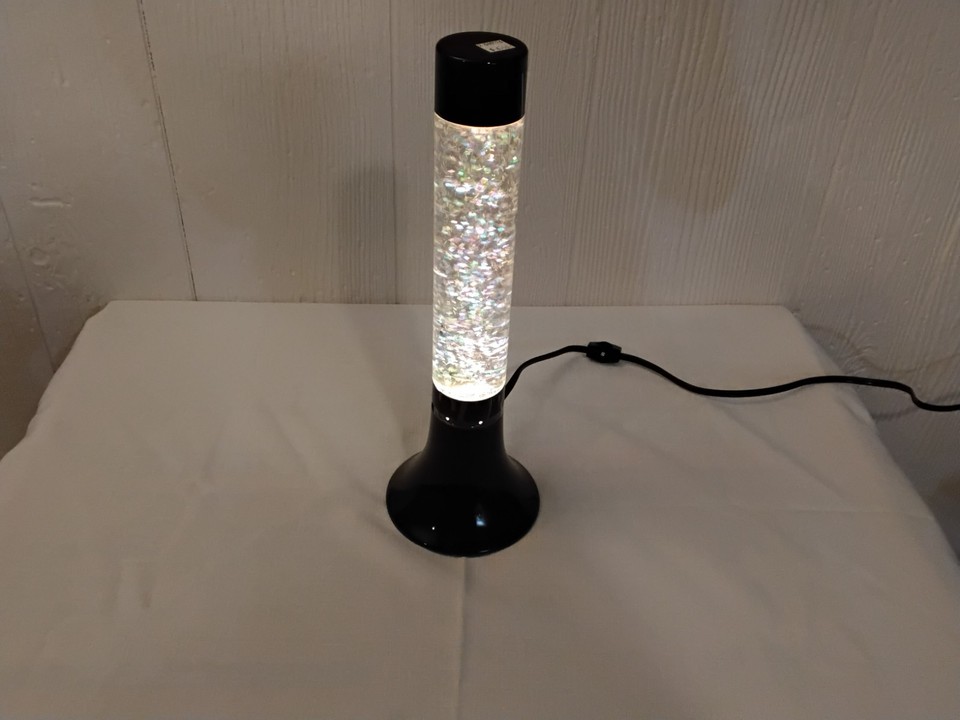 Y2K iridescent black glitter lava lamp — tested and working — hits that specific early-2000s goth-chic nostalgia harder than almost anything else out there.