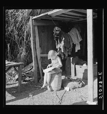 Photo:1930s Young Girl Reading Outside Rural Shack Cabin Domestic Scene