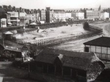 REAL PHOTO POSTCARD OF WEYMOUTH BEACH WITH BARBED WIRE BARRICADE IN 1944 WW2