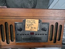 speed turntable housed in a beautiful hardwood cabinet finished with rich Sound