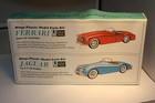 1950s Ringo Toys box showing black Jaguar XK120 and red Ferrari sports cars with green backgrounds and white text.