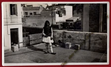 #38044 Greece 1950s. Boy [traditional costume] on rooftop. Photo PC size RPPC 