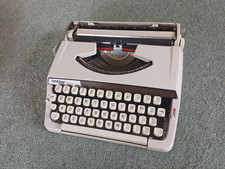 Brother Deluxe 900 Portable Typewriter with lid.
