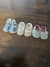 3 pairs of baby/girl shoes  soft, floral, and glittery  in various styles.