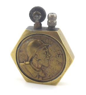 WW1 French hexagonal brass trench art petrol lighter featuring a French Poilu