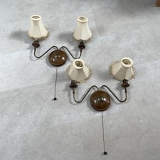 Two art deco wall lights with original shades .