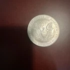 an American Silver Eagle bullion coin, featuring the Heraldic Eagle design.