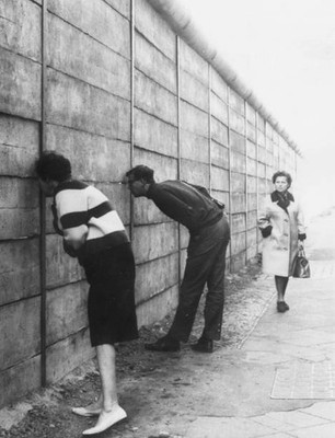 West Berliners peering through Berlin Wall into Eastern sector nea- Old Photo