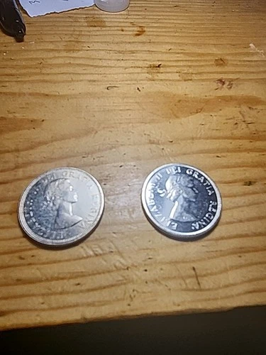 2 Total 1963 And 1964 Canada Silver Dollars.