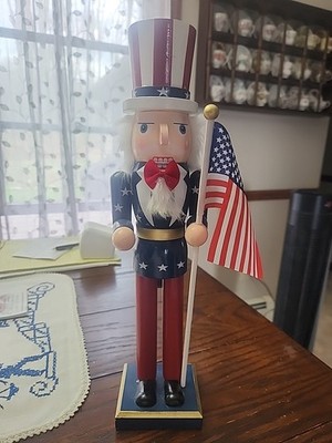 PATRIOTIC NUTCRACKER 14 inches ~ UNCLE SAM WEARING A RED BOW TIE HOLDING A FLAG