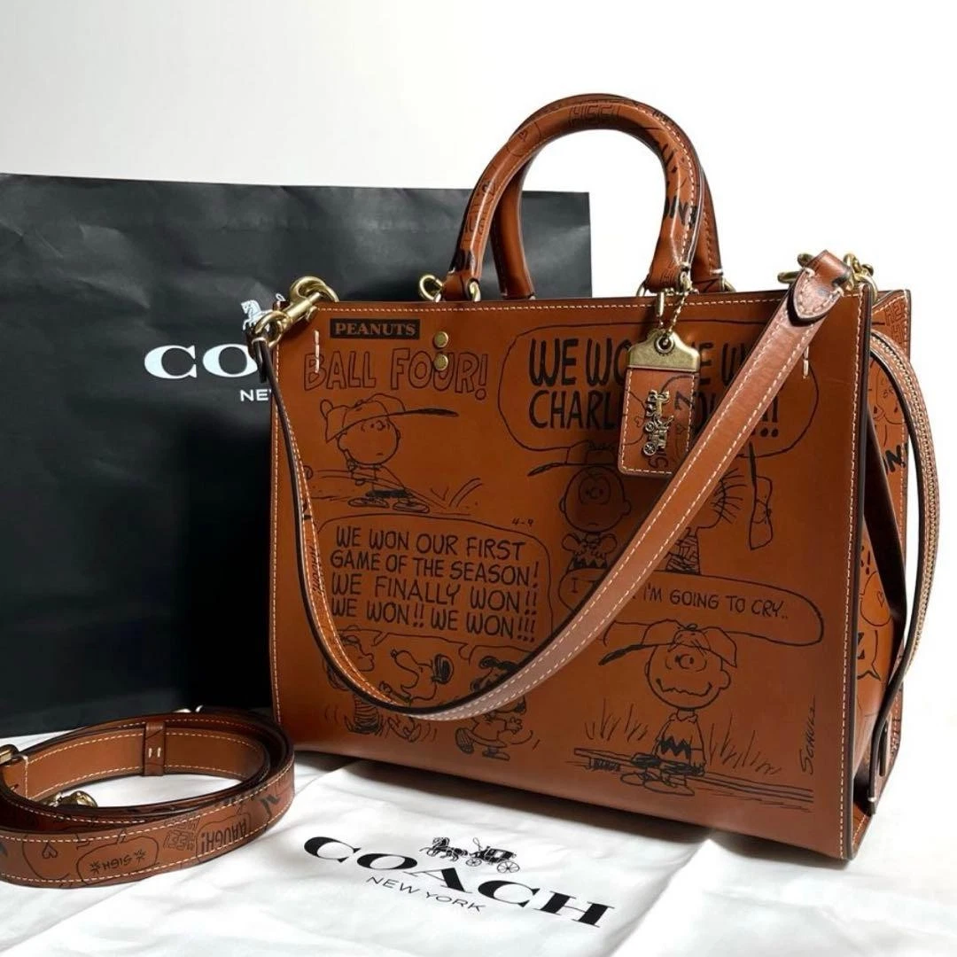 COACH x PEANUTS LIMITED EDITION HAZELNUT NEWSPRINT SNOOPY ROGUE