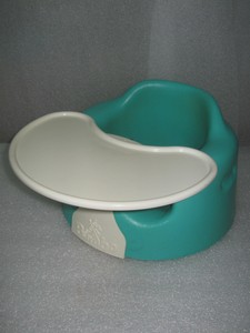 green bumbo with tray