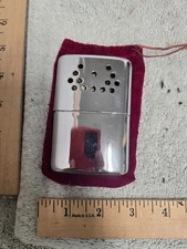 vintage pocket hand warmer Jon-e, undated, used, with cloth case