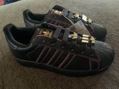 Black and pink Adidas Superstar II W sneakers feature gold trefoil lace