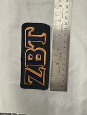 Zeta Beta Tau Embroidered Greek Letters Bronze Outline Dk Green Background