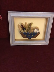 Neatly Framed Shadow Box With A Basket Of Foods