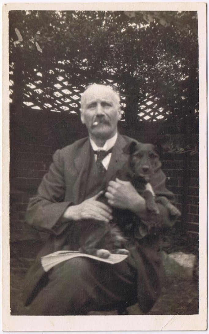 Gentleman with Moustache Smoking and Dog on Lap Holding Newspaper