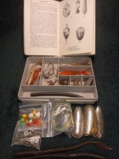 A Stewart Tackle Box Containing a mix of various Sea Fishing Tackle And A Book. 