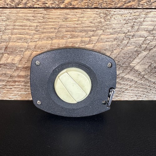 Black textured Stanley 50 foot hand crank with white circular blade and brass screw holes, made in USA.