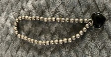 vintage silver-plated beaded charm bracelet by the brand Brighton Collectibles.