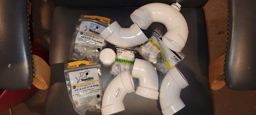 Miscellaneous lot of plumbing supplies. 2" Elbows, 2" Trap, Shark bites.