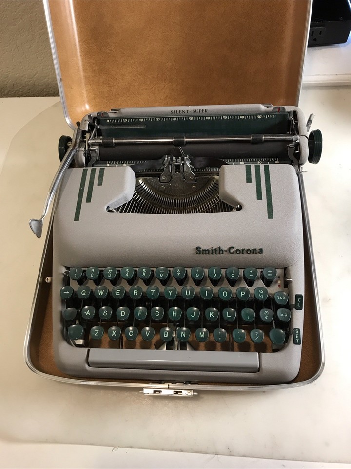 The Smith-Corona Silent Super's grey-green colorway is peak 1960s industrial chic — 'Silent' was a genuine selling point then, and it's still a stunner now.