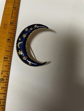 Blue enamel crescent moon pin with gold colored and crystal celestial highlights