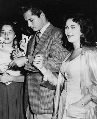 Actor John Derek signing autographs for fans as fan Mickey Mosko h- Old Photo