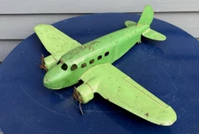 Vintage pressed steel toy airplane prop plane Wyandotte DC3 green paint 1940's