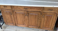 Kitchen cabinets have a Dual Sink Station with Ceramic Countertops