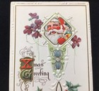1915 EMBOSSED CHRISTMAS GREETING POSTCARD, SANTA CLAUS, TOYS, FLOWERS, HOLLY — photo 2