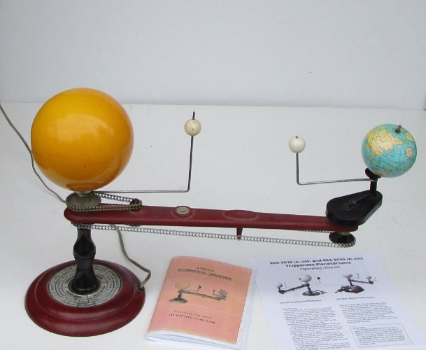 A vintage mechanical orrery — a working model of the solar system — is basically the nerdiest, most jaw-dropping desk object that exists.