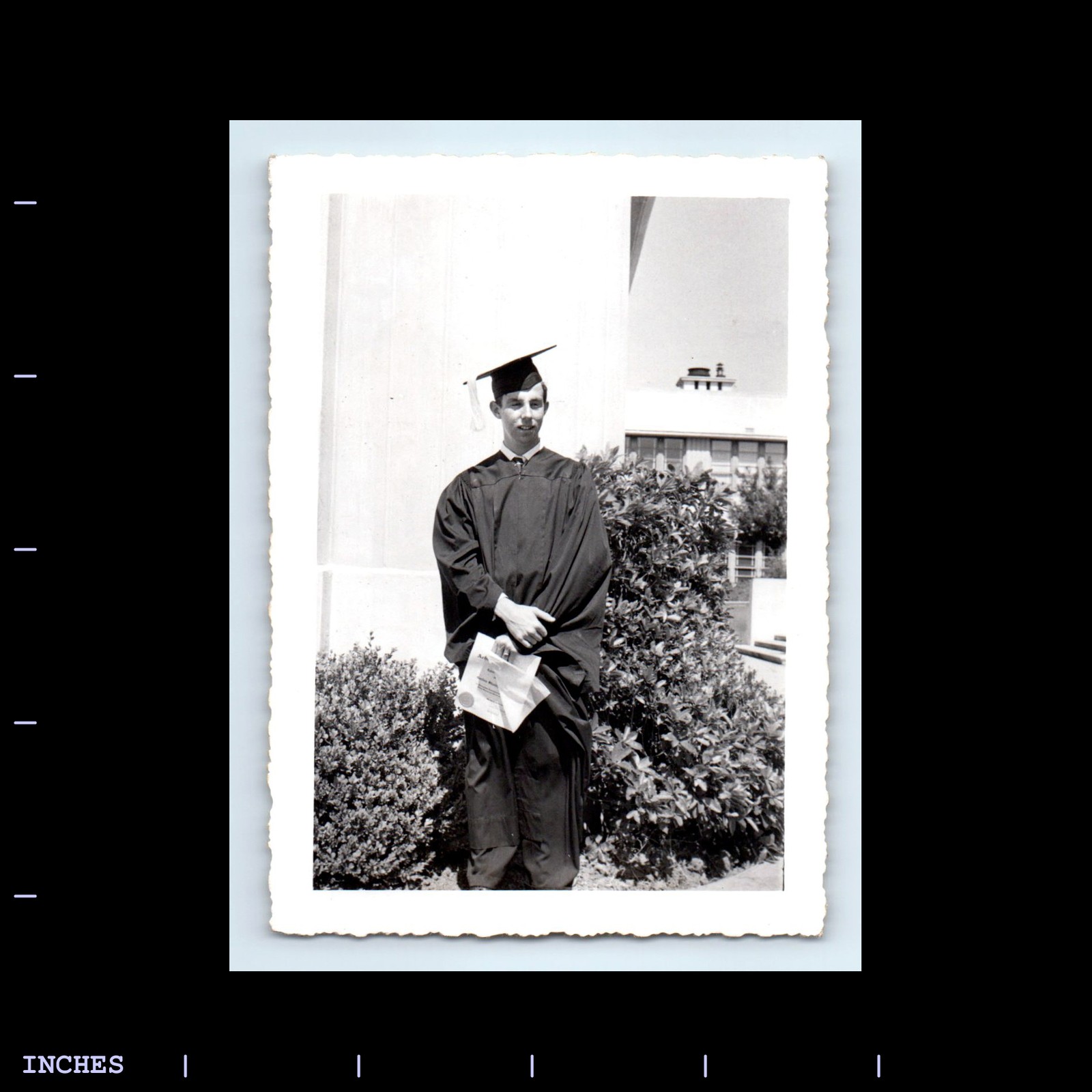 Vintage Man in Graduation Cap and Gown Holding Diploma Photo