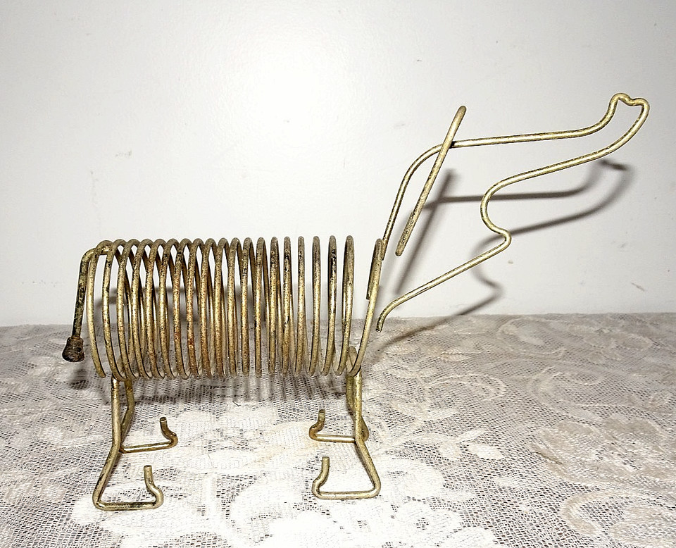 A 1960s wire elephant memo holder with trunk-up for good luck — charming mid-century desk whimsy that actually holds your bills.