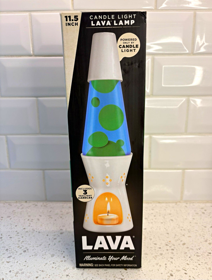 A candle-powered lava lamp with a white ceramic base — no electricity, just heat from a candle doing the work, which is a genuinely clever and rare mechanism.