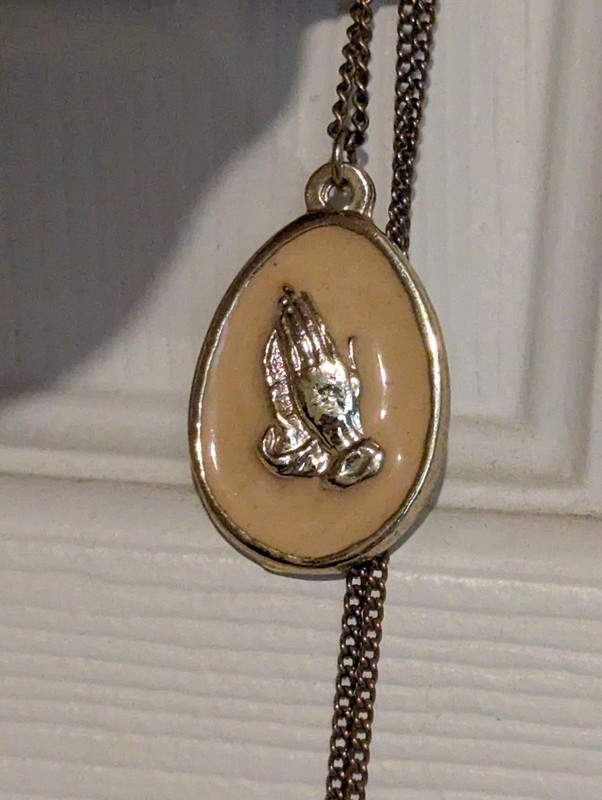 A Pendant With Two Adult Hands with Each other In A State Of Prayer Or Clapping