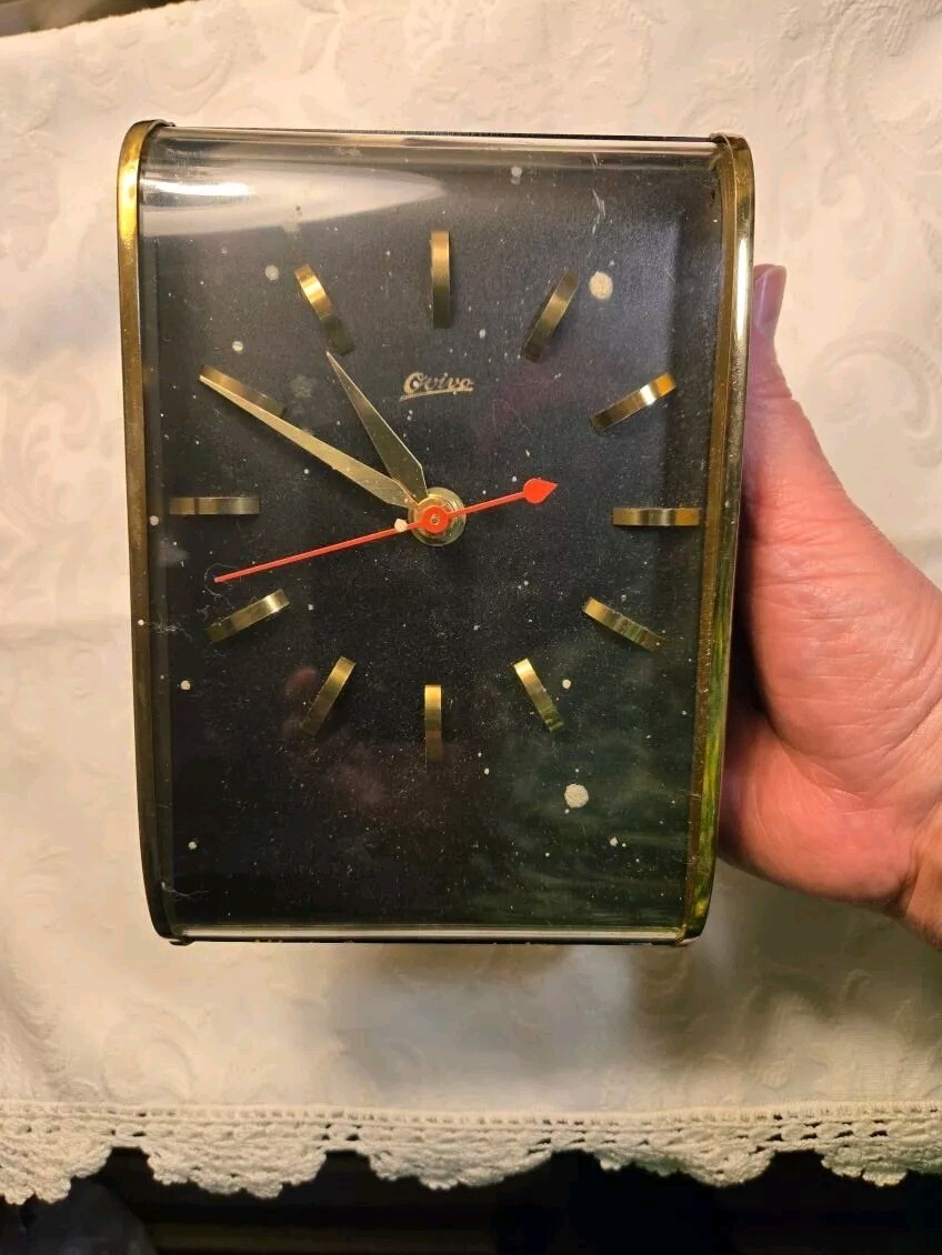 Vtg. MCM Ovivo brass ish and black metal wall clock.